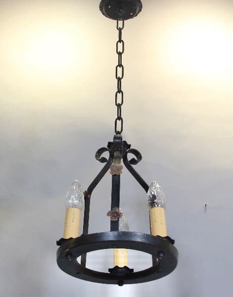 Vintage wrought iron chandelier with candles.