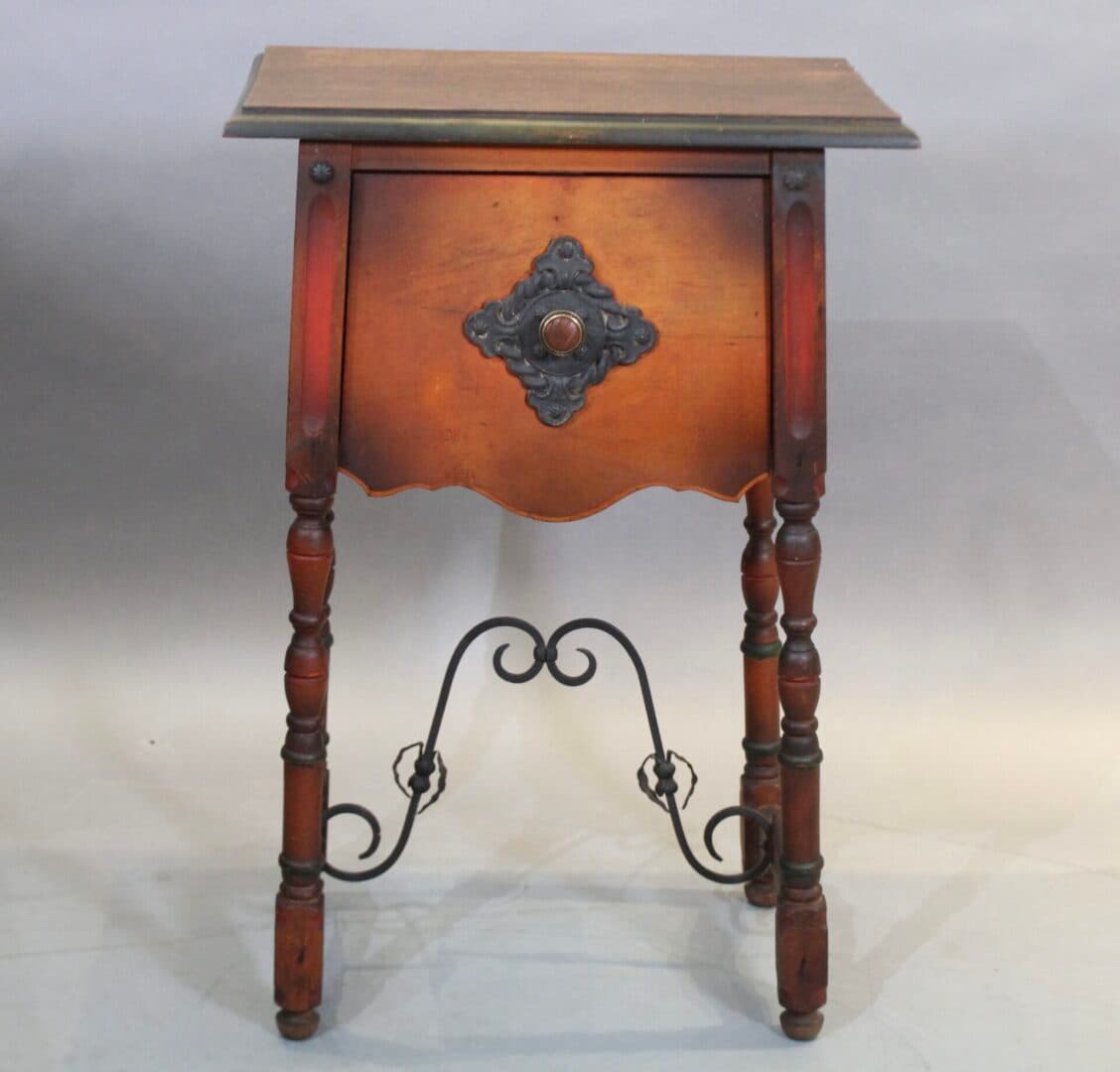Ornate wooden side table with decorative metal accents.