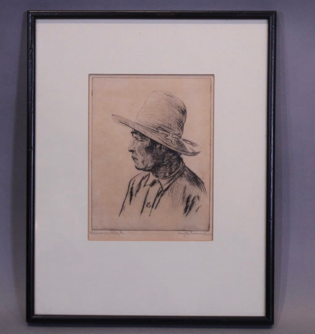 Framed sketch of person wearing hat.