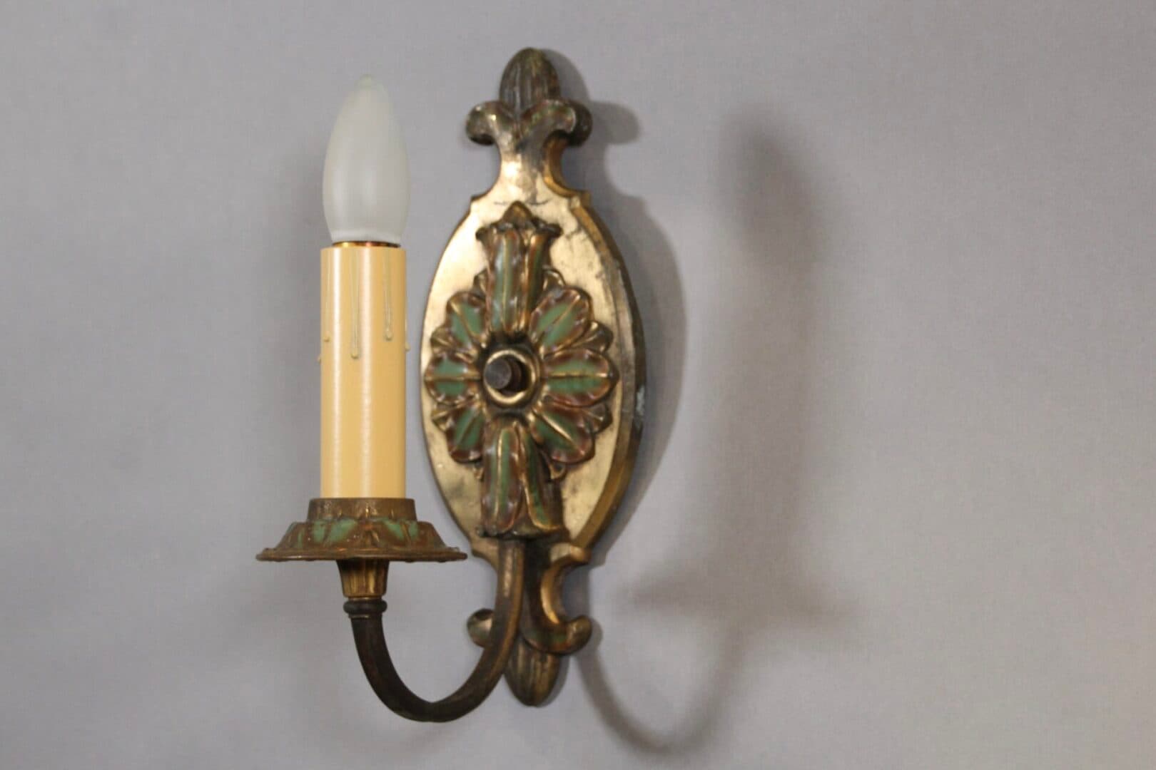 Vintage brass wall sconce with bulb.