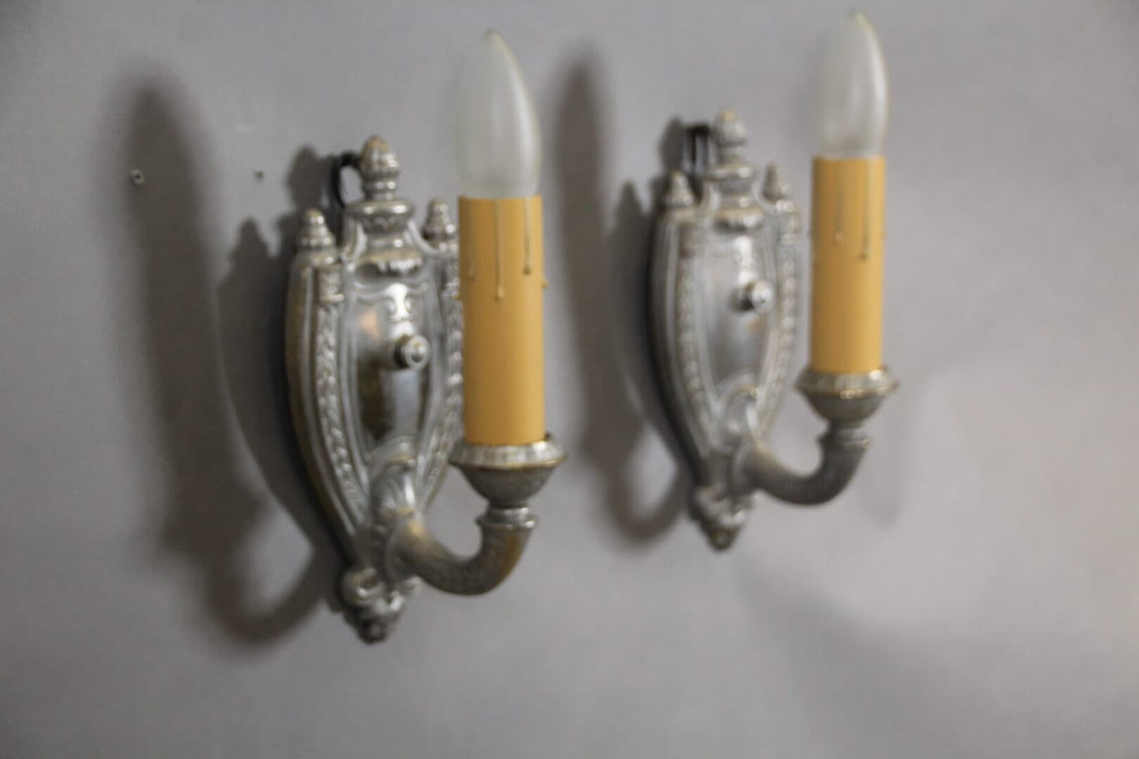 Two vintage wall sconces with bulbs.