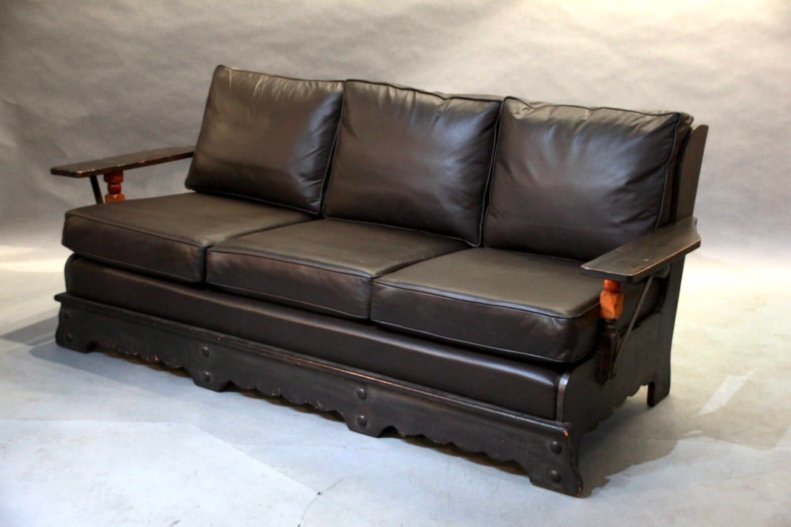 40523. Signed Monterey Sofa With Metal Straps And Leather Upholstery