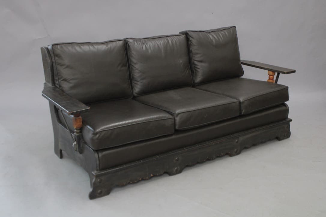 Black leather three-seater sofa
