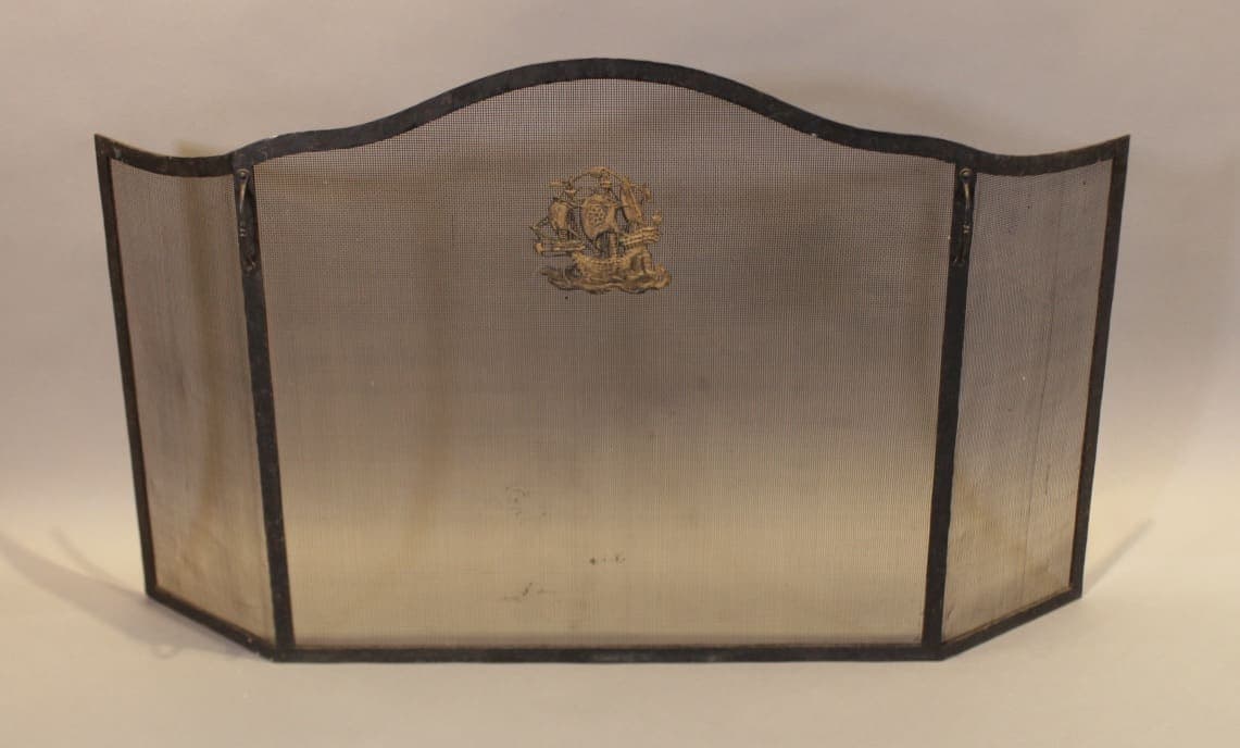 Three-panel metal fireplace screen with crest