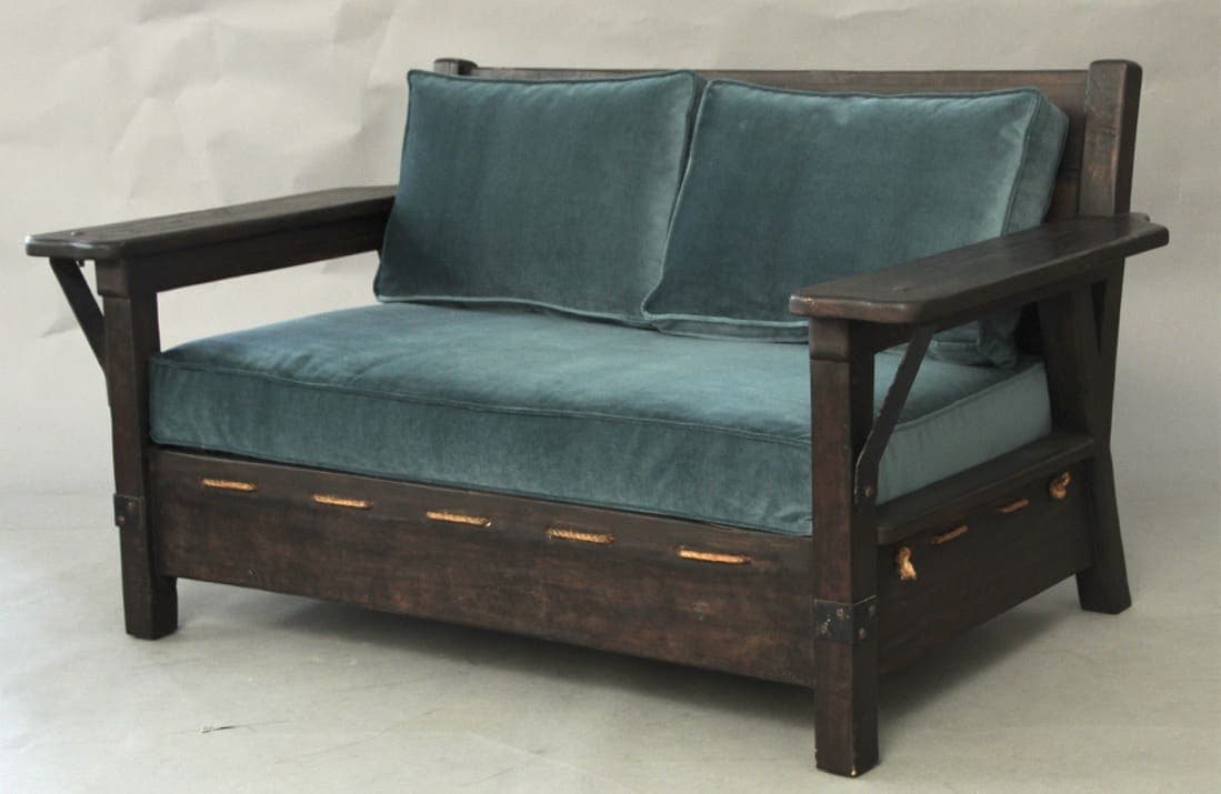 Rustic wooden loveseat with teal cushions