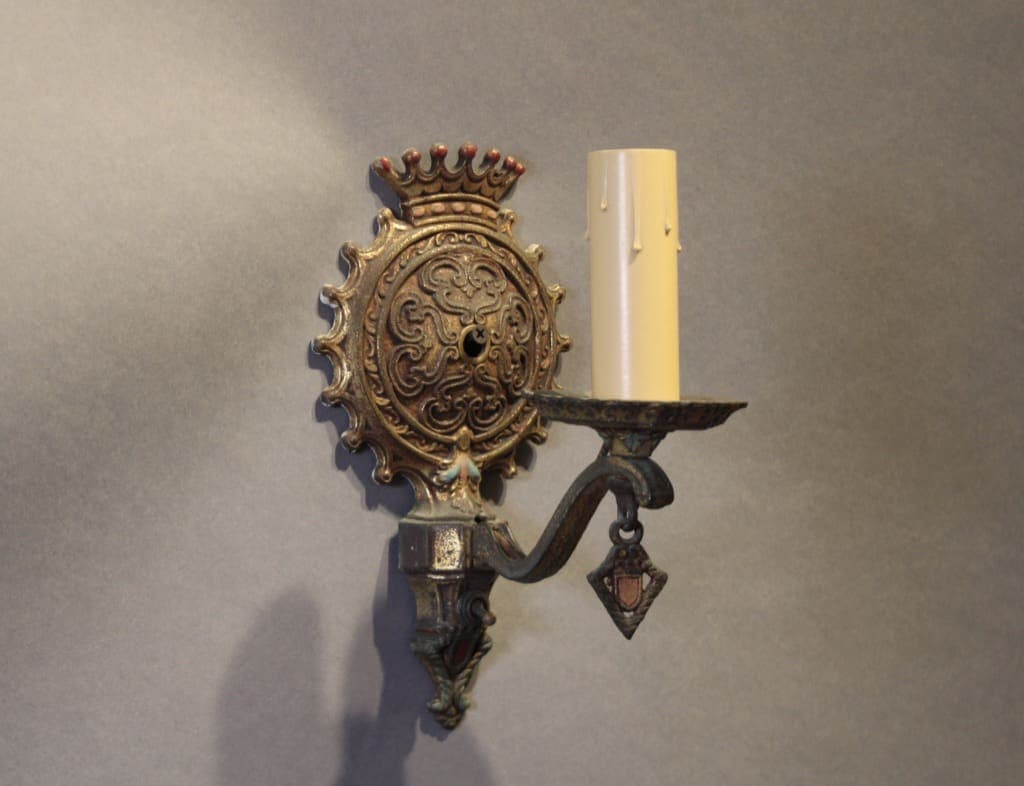 Ornate brass wall sconce with candle