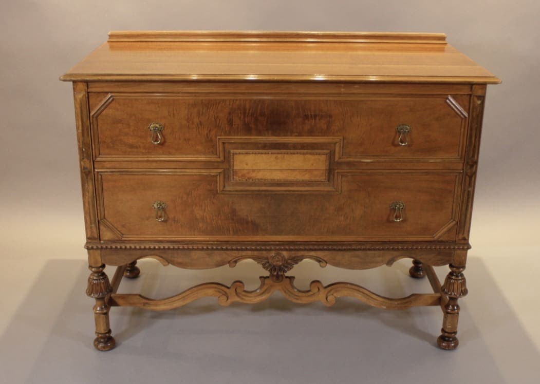 Antique wooden two-drawer dresser with carved legs