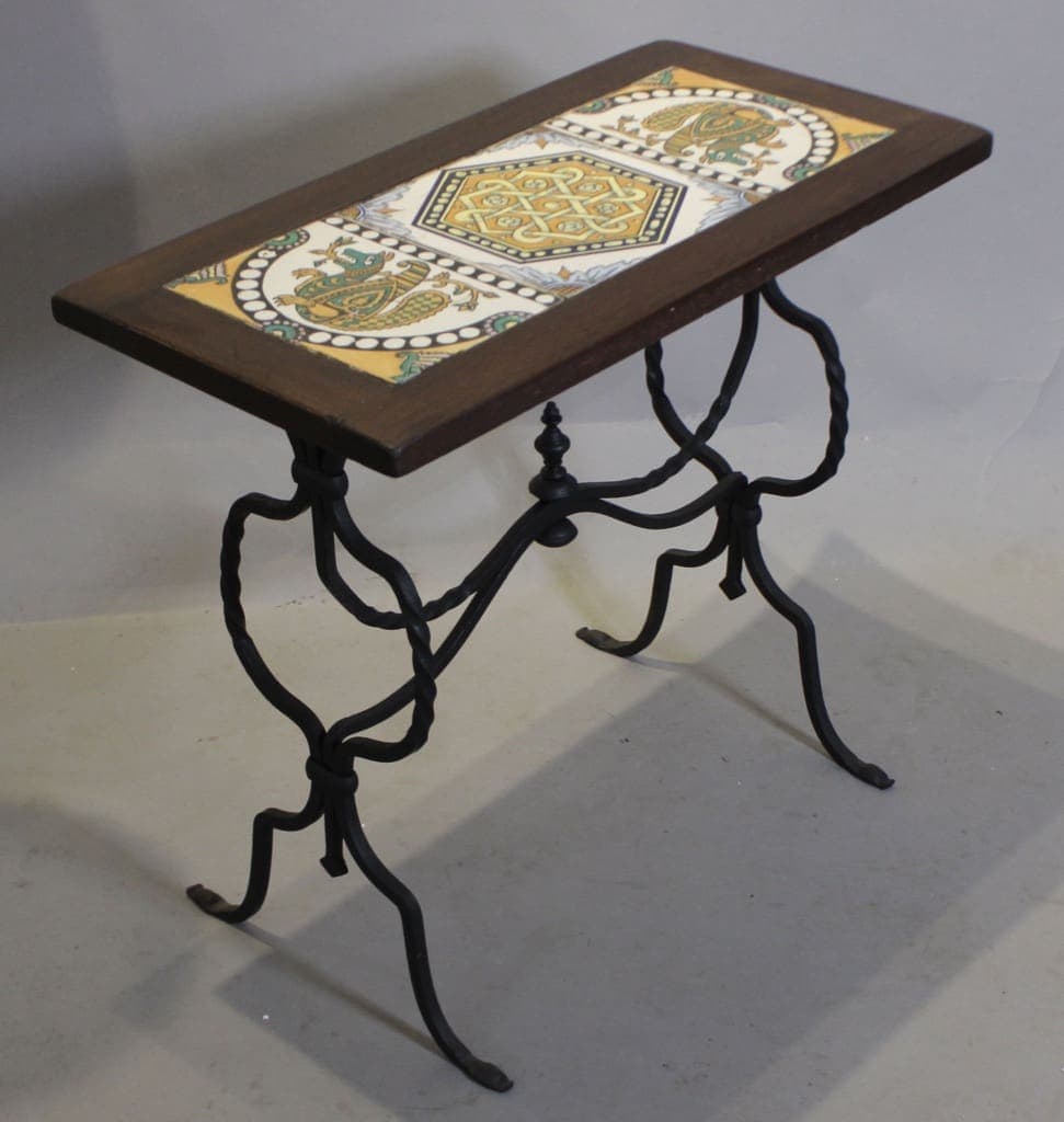 Small decorative tile-top wooden table with iron legs