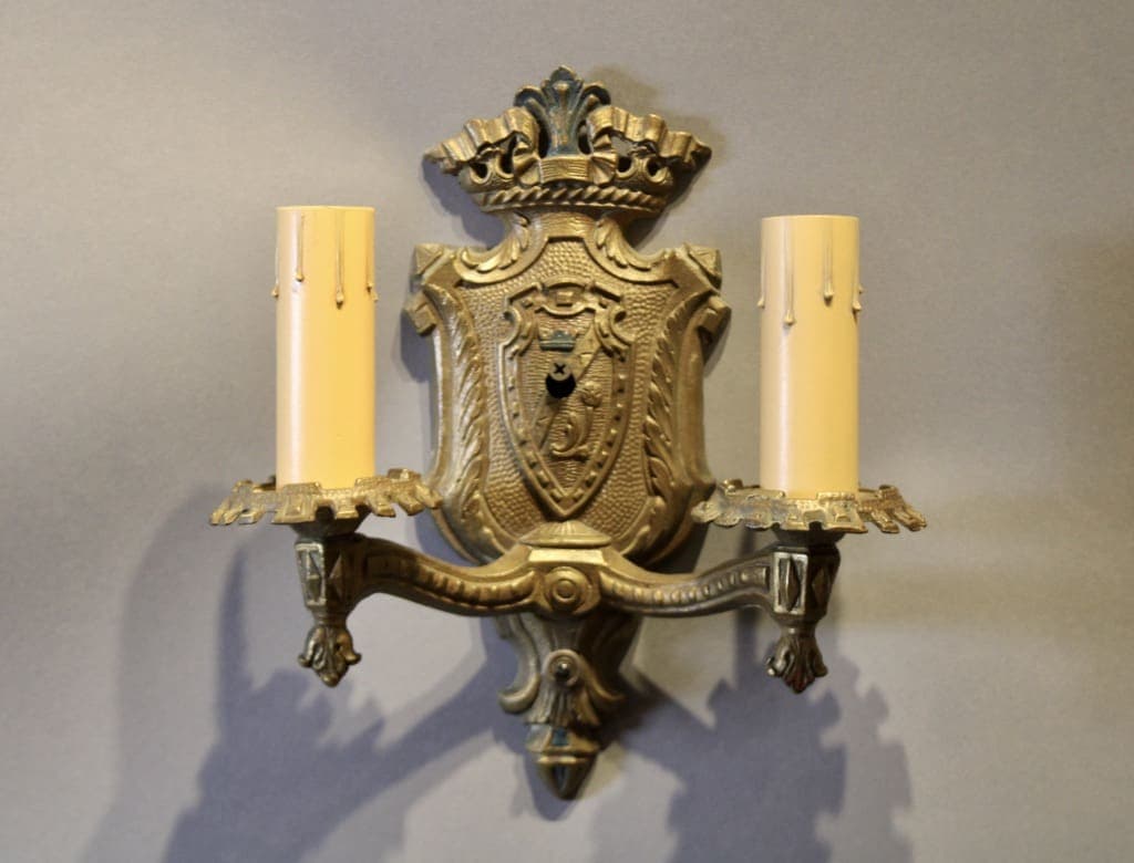 Crested shield brass wall light with faux candles