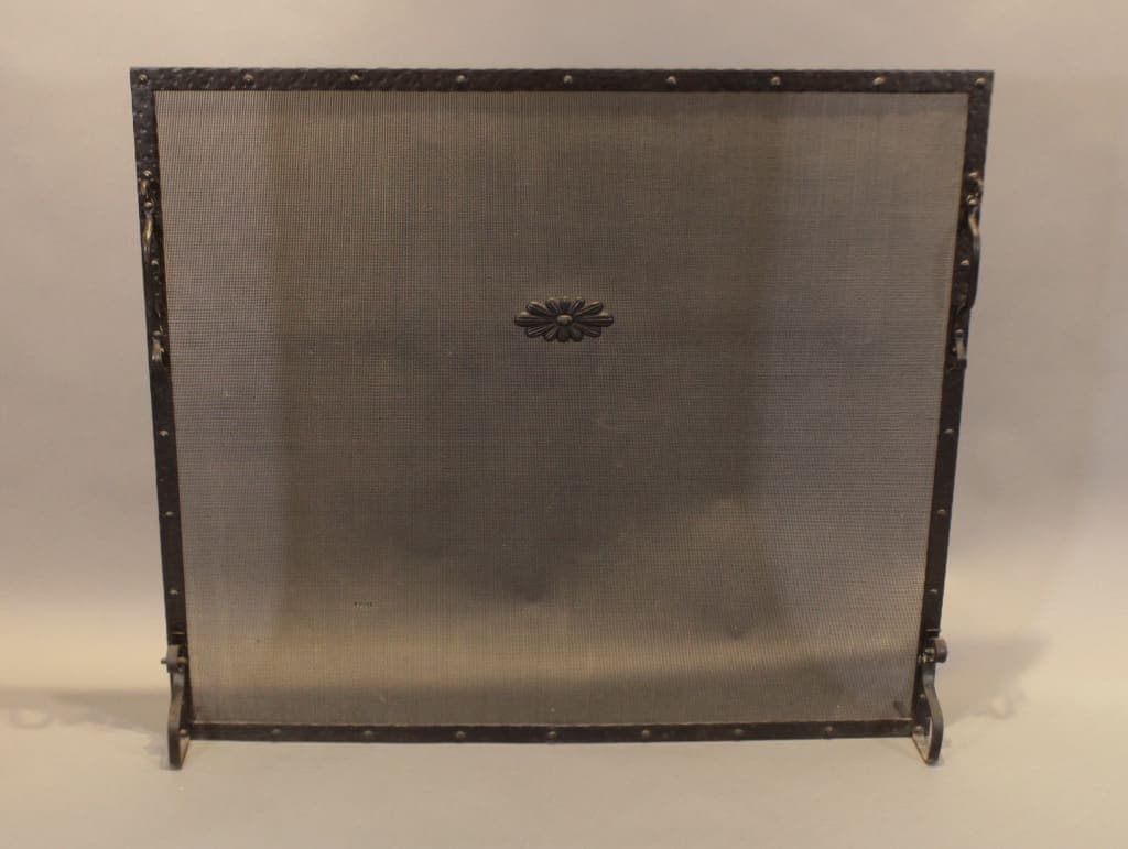 Iron fireplace screen with central floral medallion