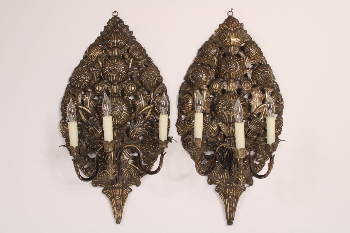 Pair of baroque style brass repoussee wall sconces.