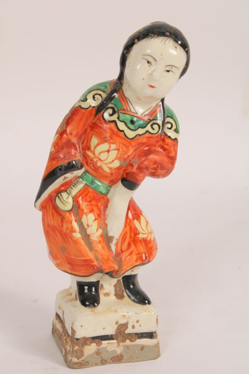 Asian polychrome decorated stoneware figure