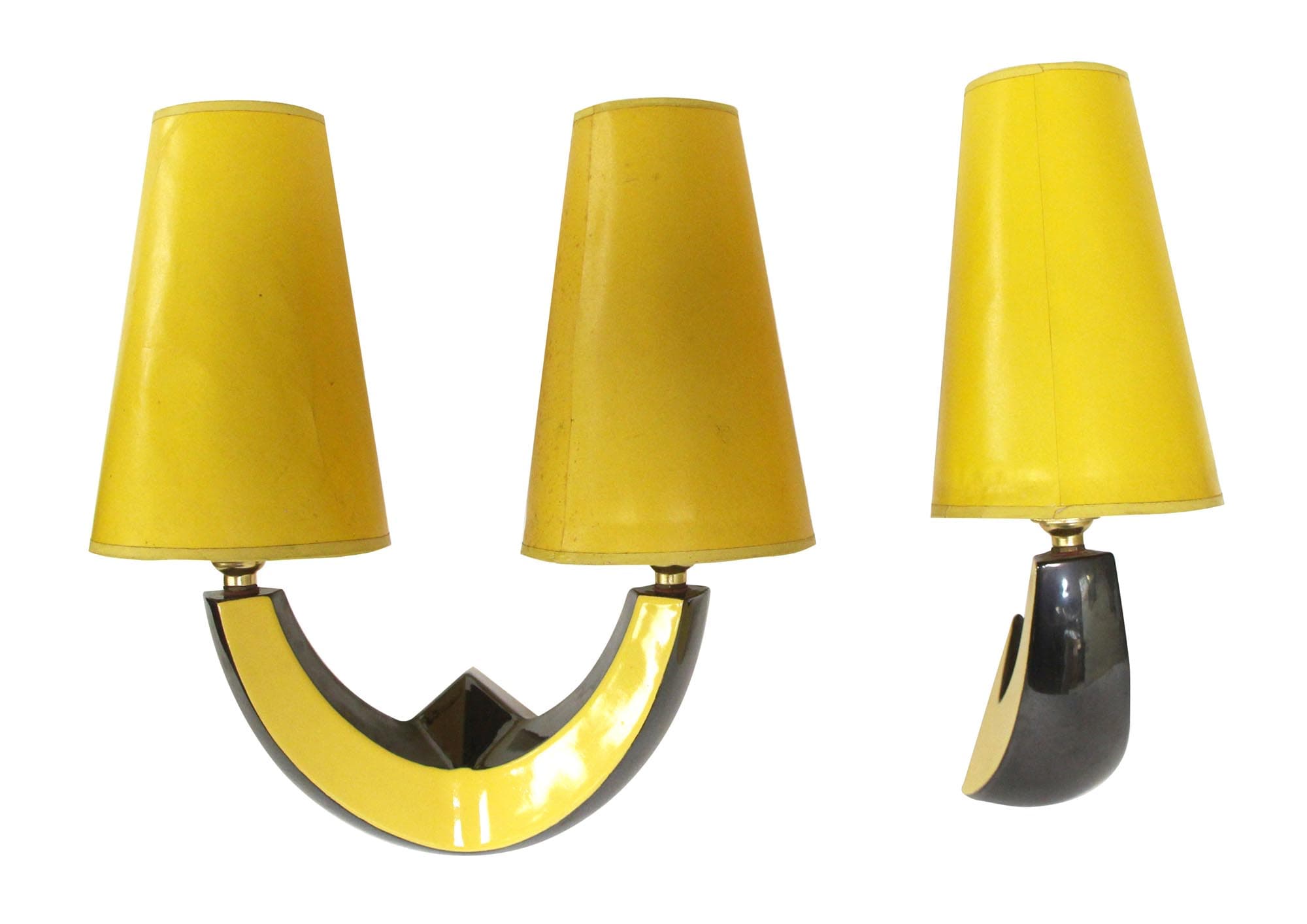 Set of two mid century modern wall sconces in black and yellow ceramic with yellow shades, shown with one double-arm sconce and one single-arm sconce.