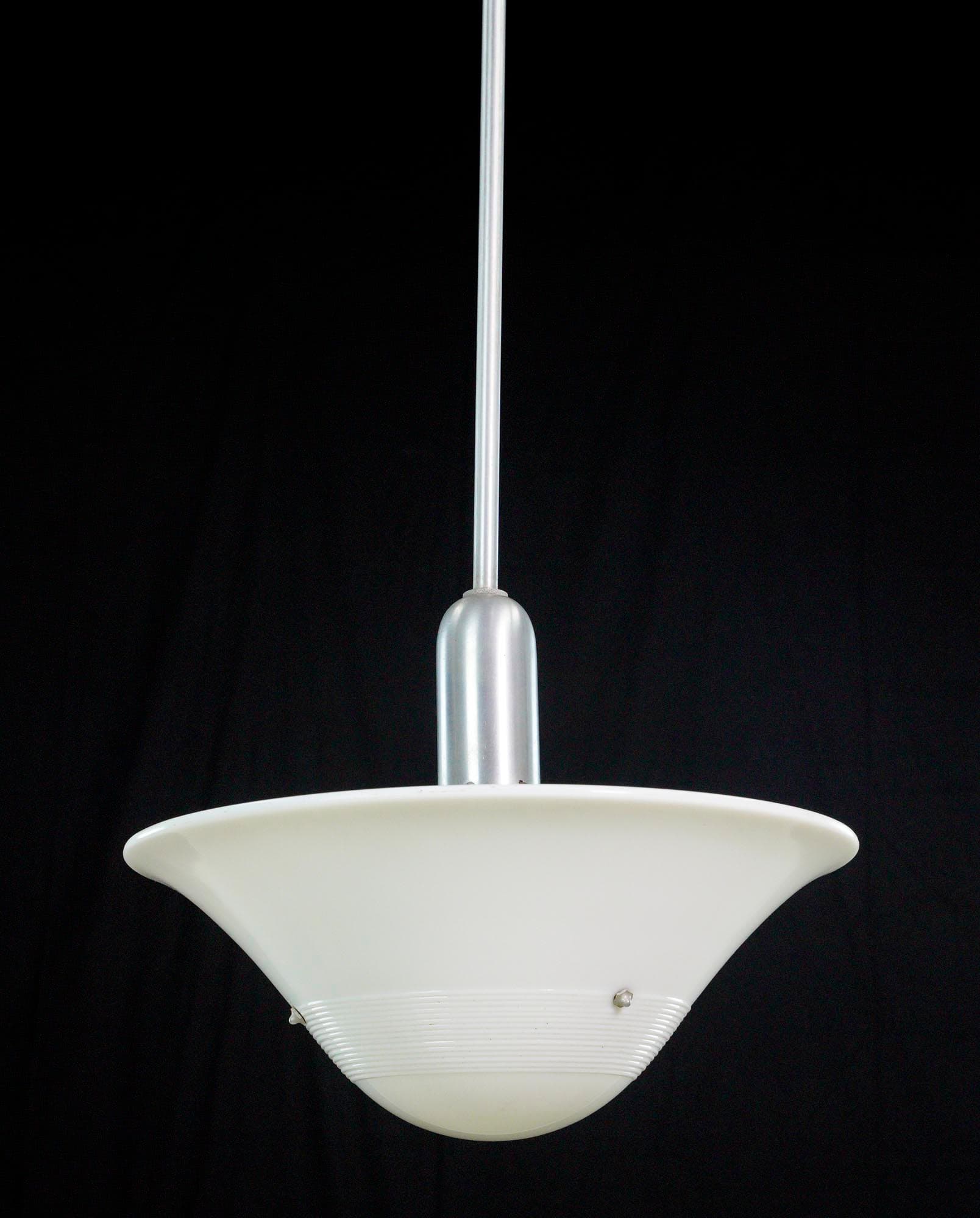 Mid-century pendant light with a white milk glass dish shade and a steel pole.